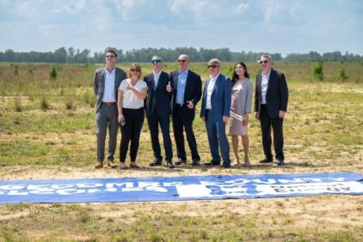 business people standing in open field